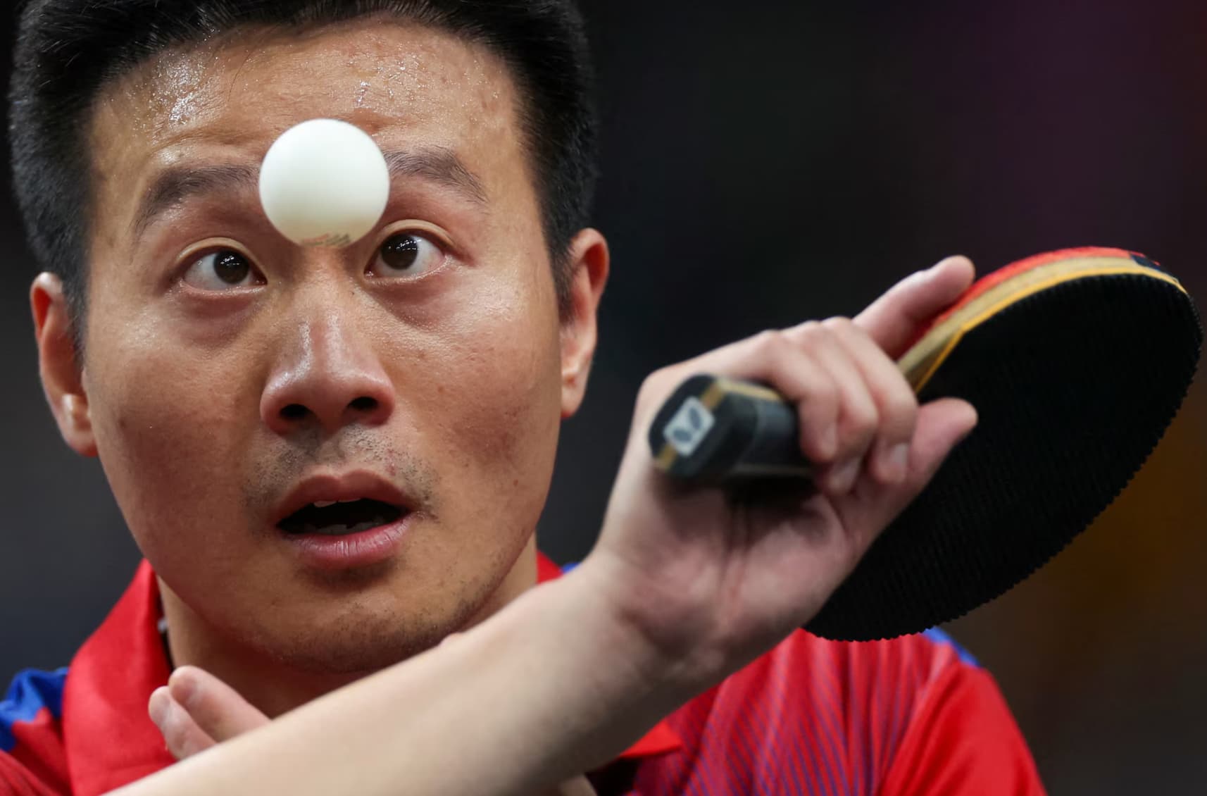 A Slovakian table tennis player goes all in during a match. 